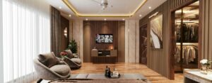 Camera da letto in stile quiet luxury con arredi su misura in legno scuro, cabina armadio illuminata, poltrone dal design morbido, illuminazione integrata e finiture di pregio dai toni neutri.